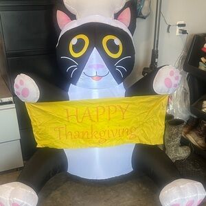 Black & White Inflatable Cat Holding Yellow "Happy Thanksgiving" Banner